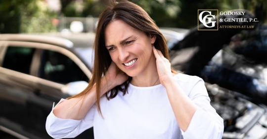 woman holding her neck after a car crash