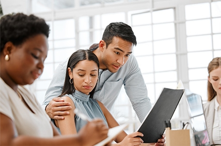 lawyers reviewing documents together in a bright office meeting room